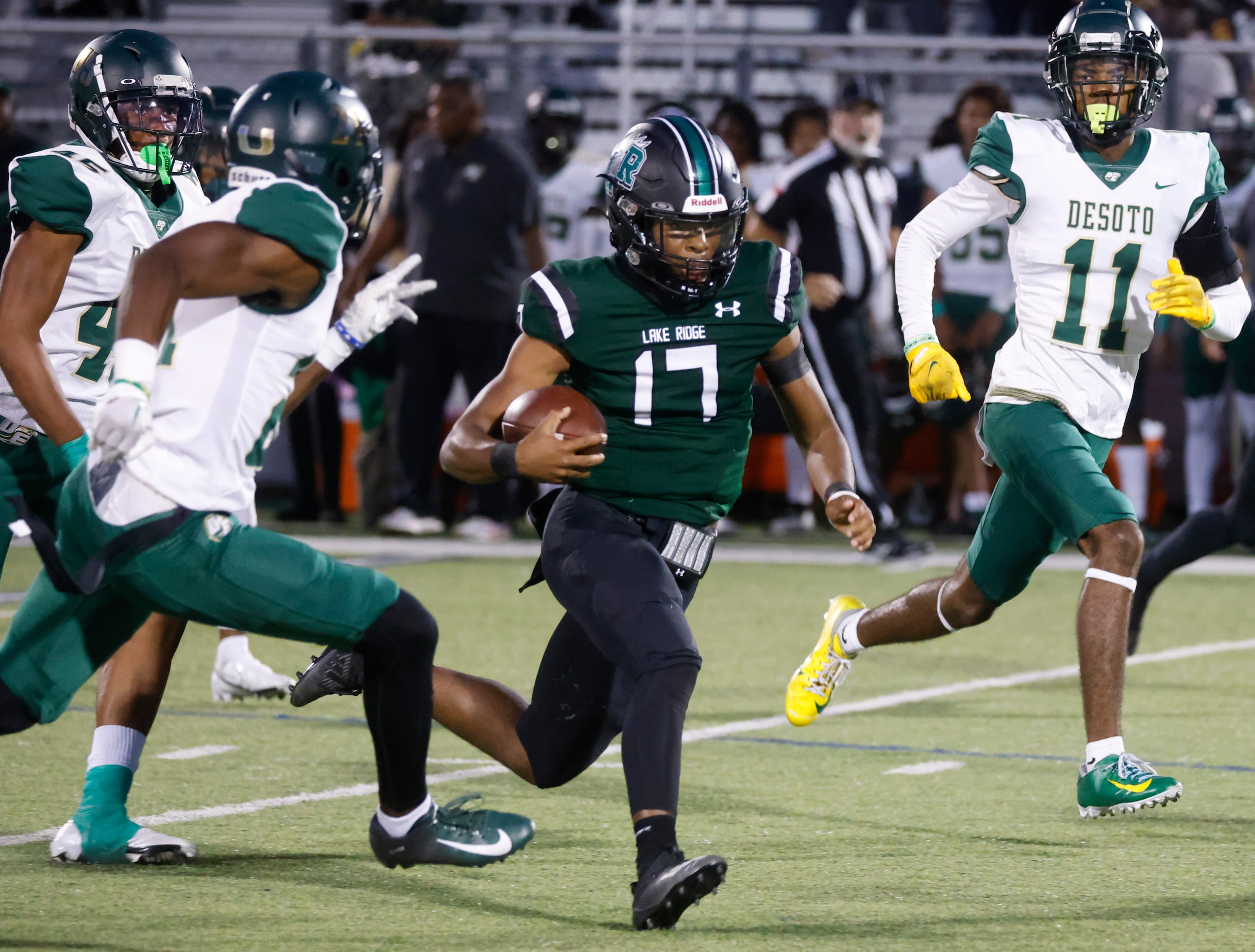 Lake Ridge High School’s Kennen Miller (17) runs past DeSoto defenders during the second...