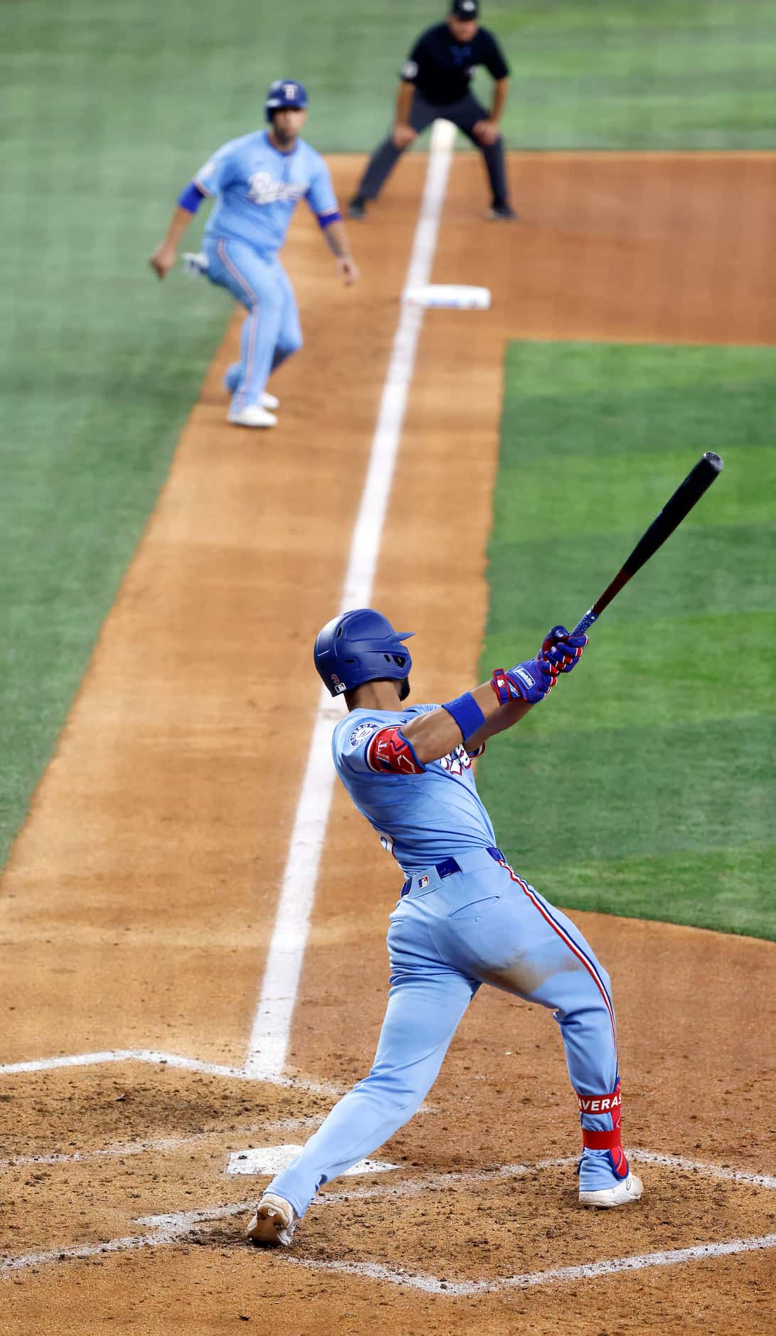 Texas Rangers outfielder Leody Taveras (3) connects on an opposite field single that scored...