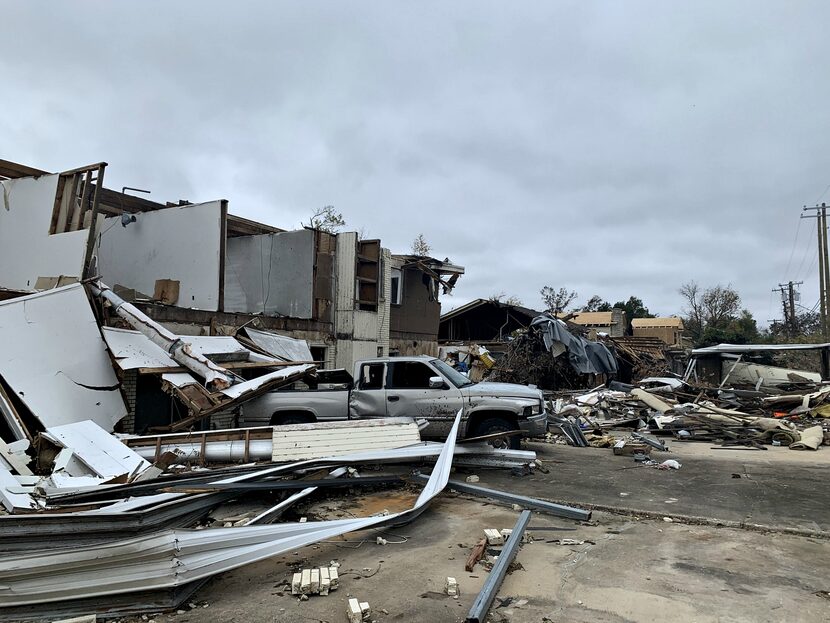 Smashed-up vehicles and shattered townhouses remain along Glenrio Drive, where it looks like...