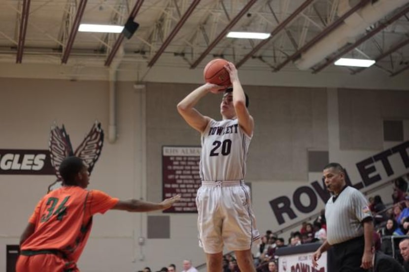 
Rowlett senior Blake Bushnell shoots over a Garland Naaman Forest defender in Rowlett’s...