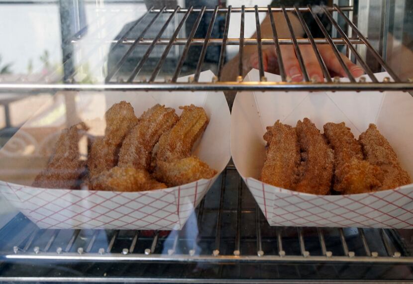 Haleigh Cox sets out fresh churros at Saint Sofia's in Fort Worth.