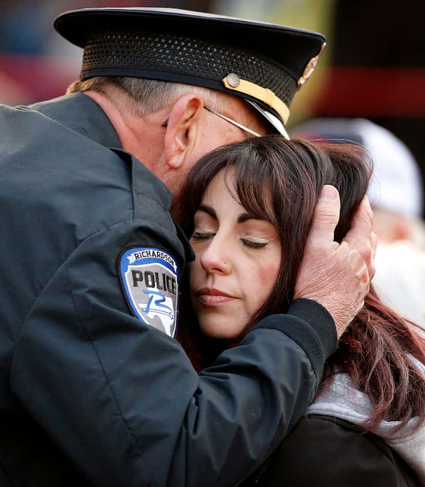 Richardson police chief Jimmy Spivey hugs Nicole Sherrard, wife of slain Richardson police...