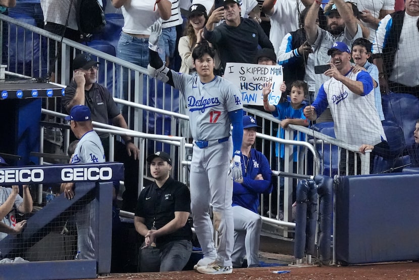 Los Angeles Dodgers' Shohei Ohtani (17) waves to fans after he hit a home run scoring Andy...