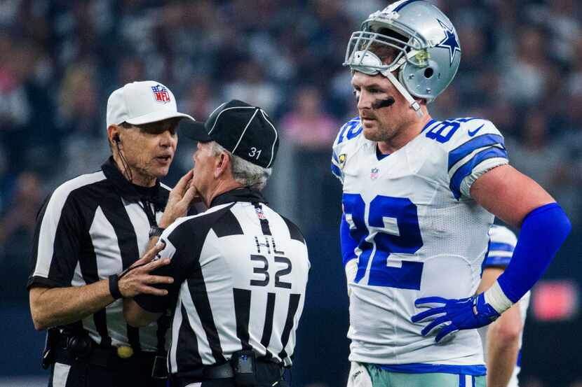 Dallas Cowboys tight end Jason Witten (82) listens to referee Tony Corrente (99) and head...