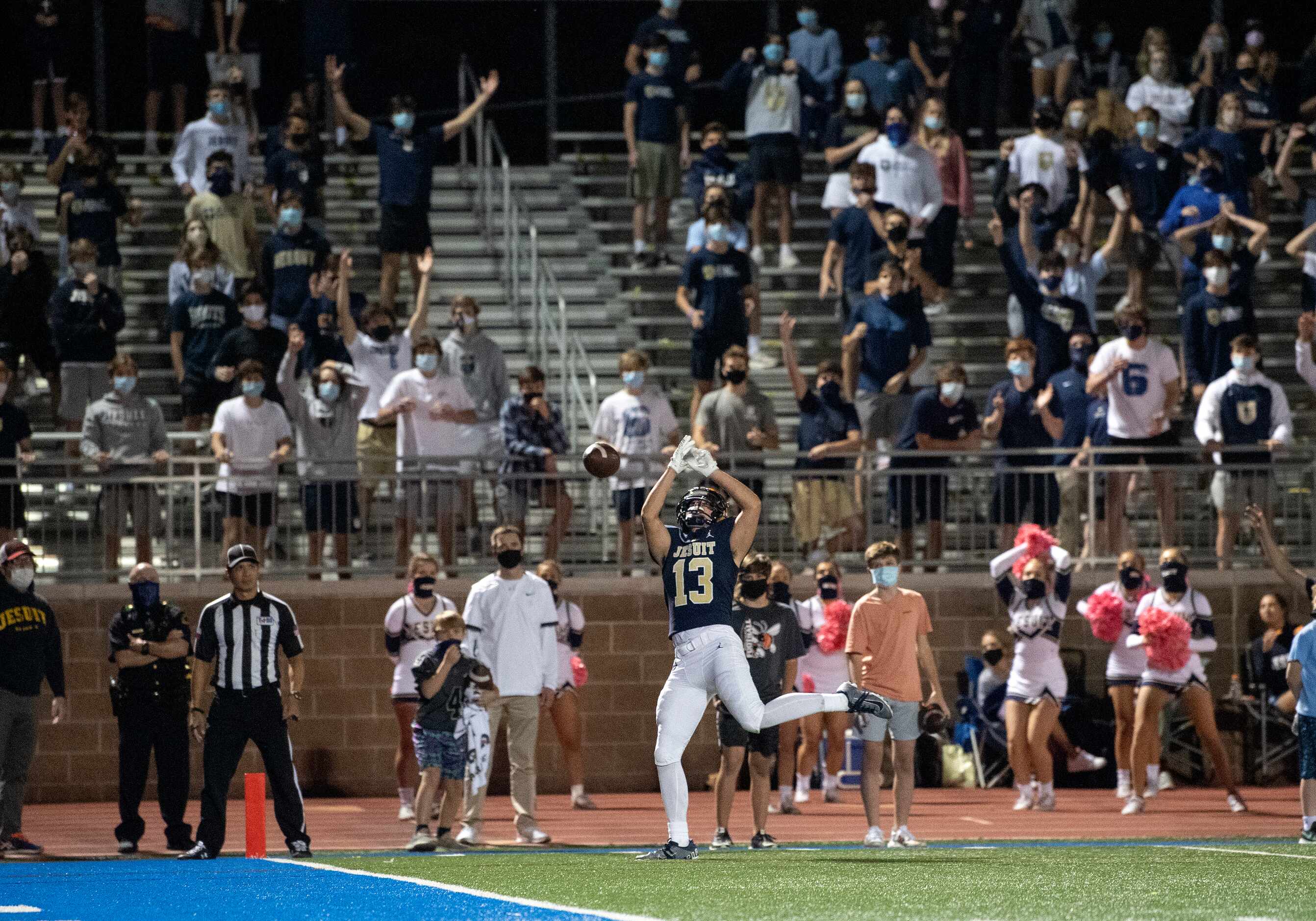 Fans react as Jesuit senior wide receiver Ryan Schurr (13) cannot bring in a potential...