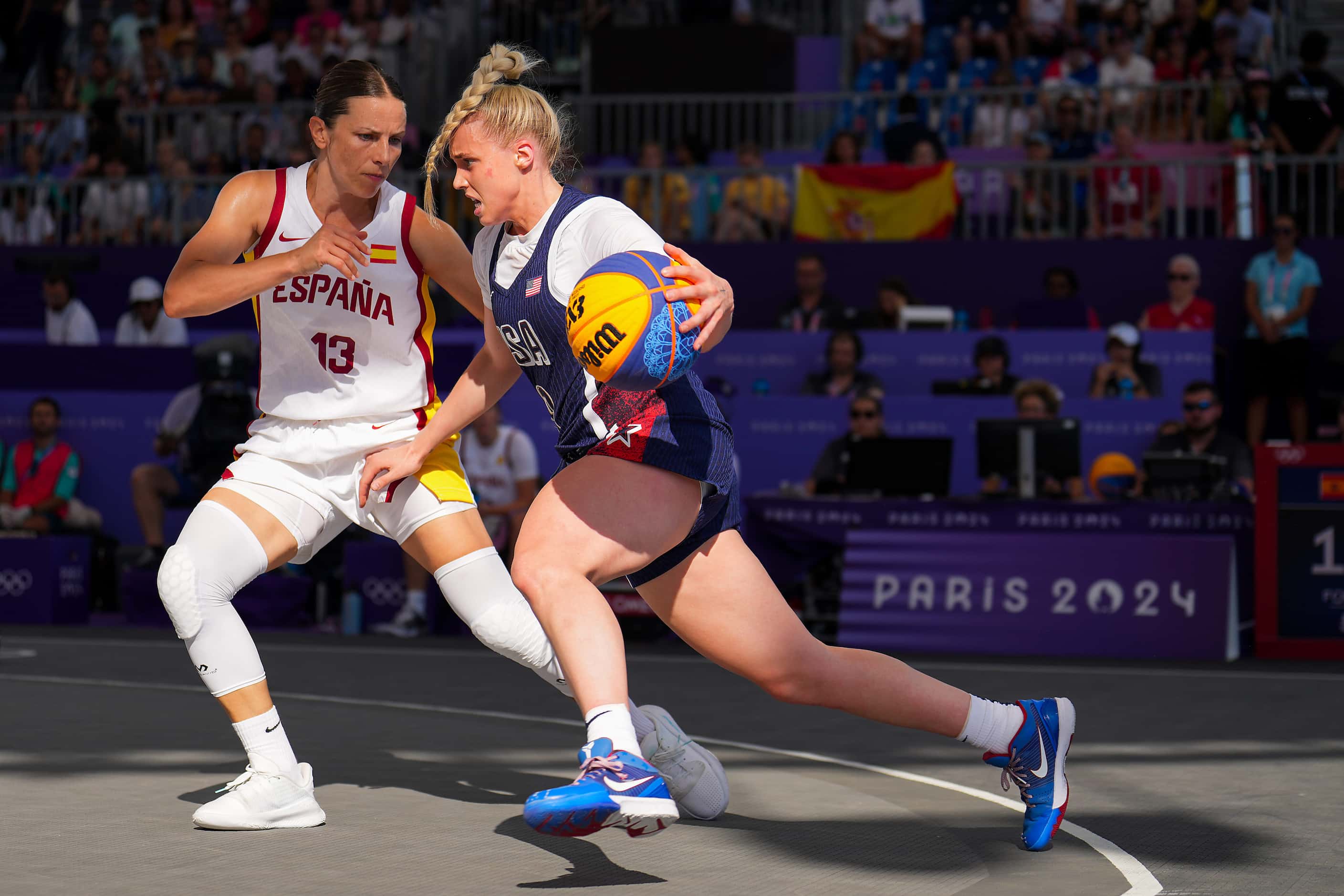 Hailey van Lith (9) of the United States is defended by Spain’s Sandra Ygueravide (13)...