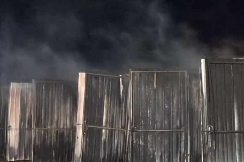 Storage units smolder after a fire struck a boat repair shop Tuesday morning in Grapevine.