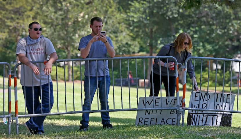 From left to right: On Monday John Storm, William Fears and Reagan Watson protested the...