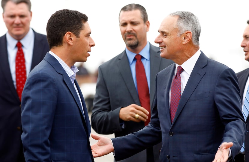 MLB Commissioner Rob Manfred (right) visits with Texas Rangers general manager Jon Daniels...