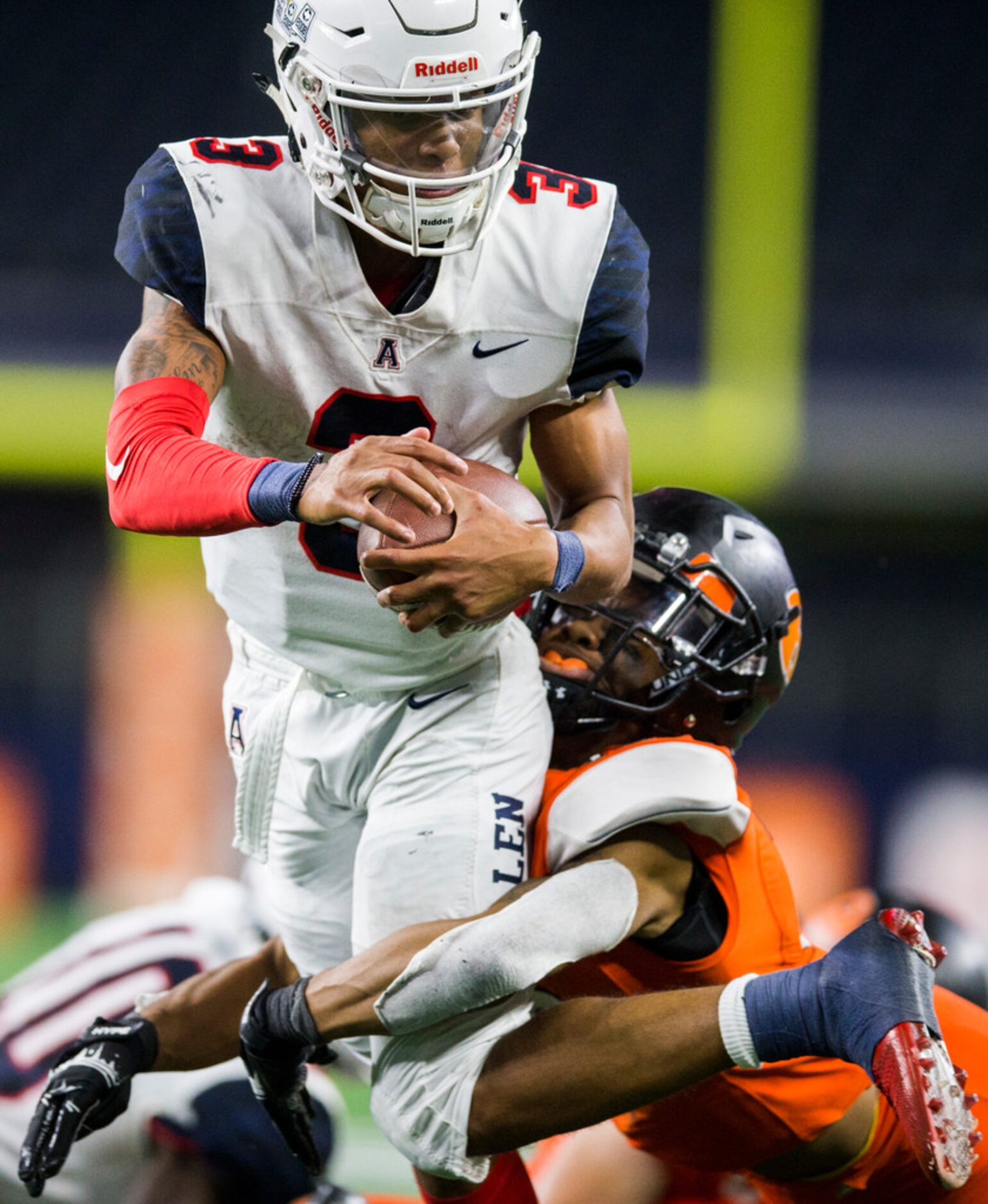 Allen quarterback Raylen Sharpe (3) is tackled by Rockwall defensive back Karson Hill (15)...