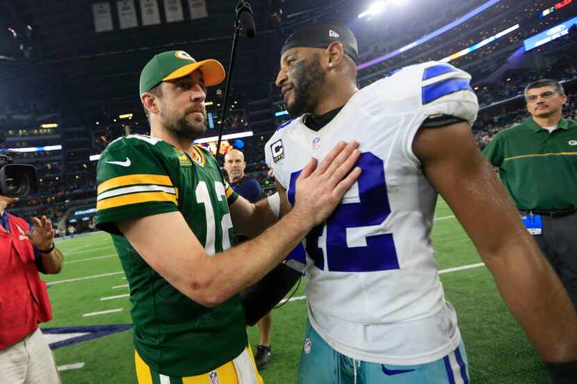 Green Bay Packers' Aaron Rodgers talks to Dallas Cowboys' Barry Church after an NFL...