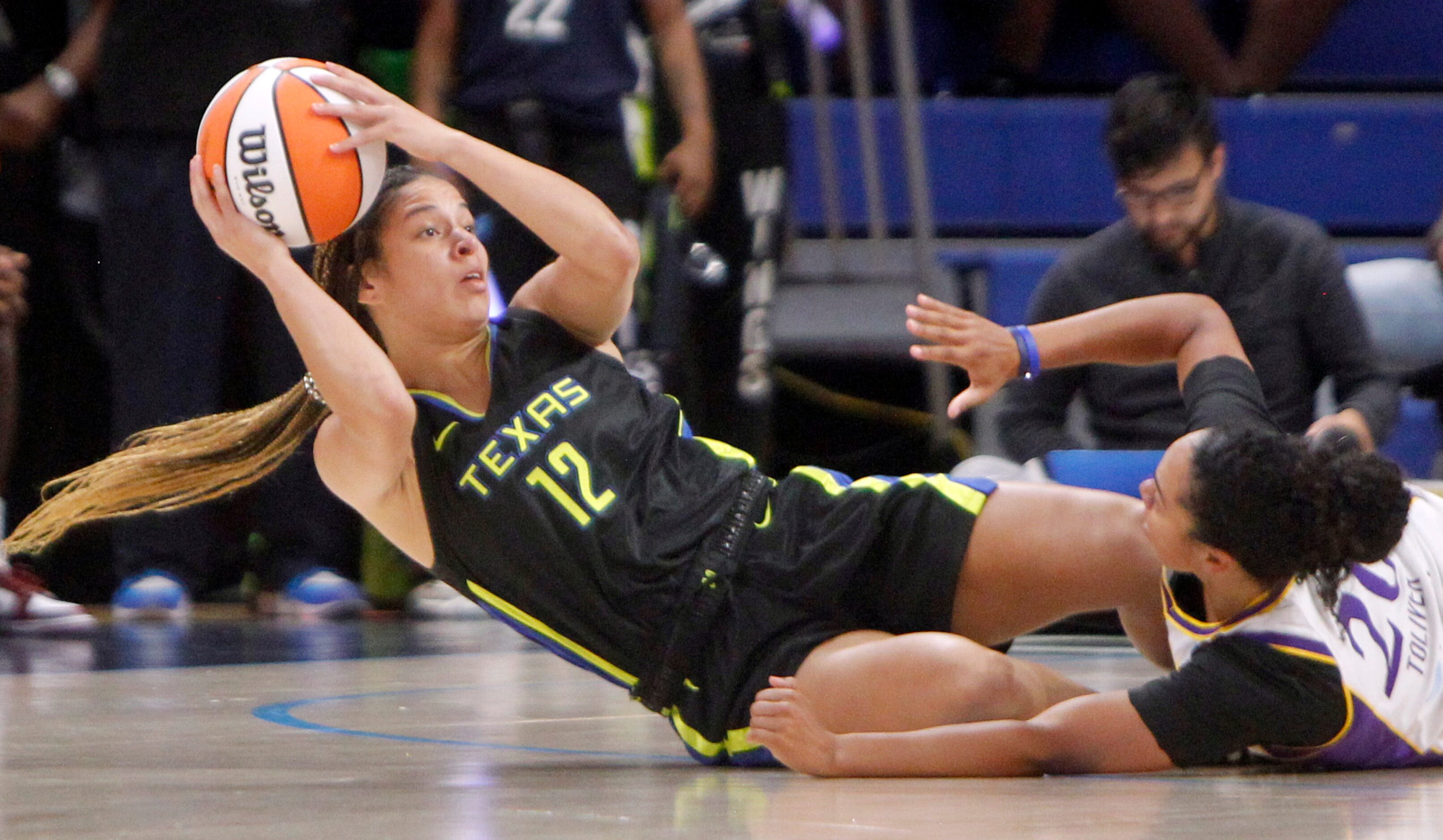 Dallas Wings guard Veronica Burton (12) gets off a pass to a teammate after battling with LA...