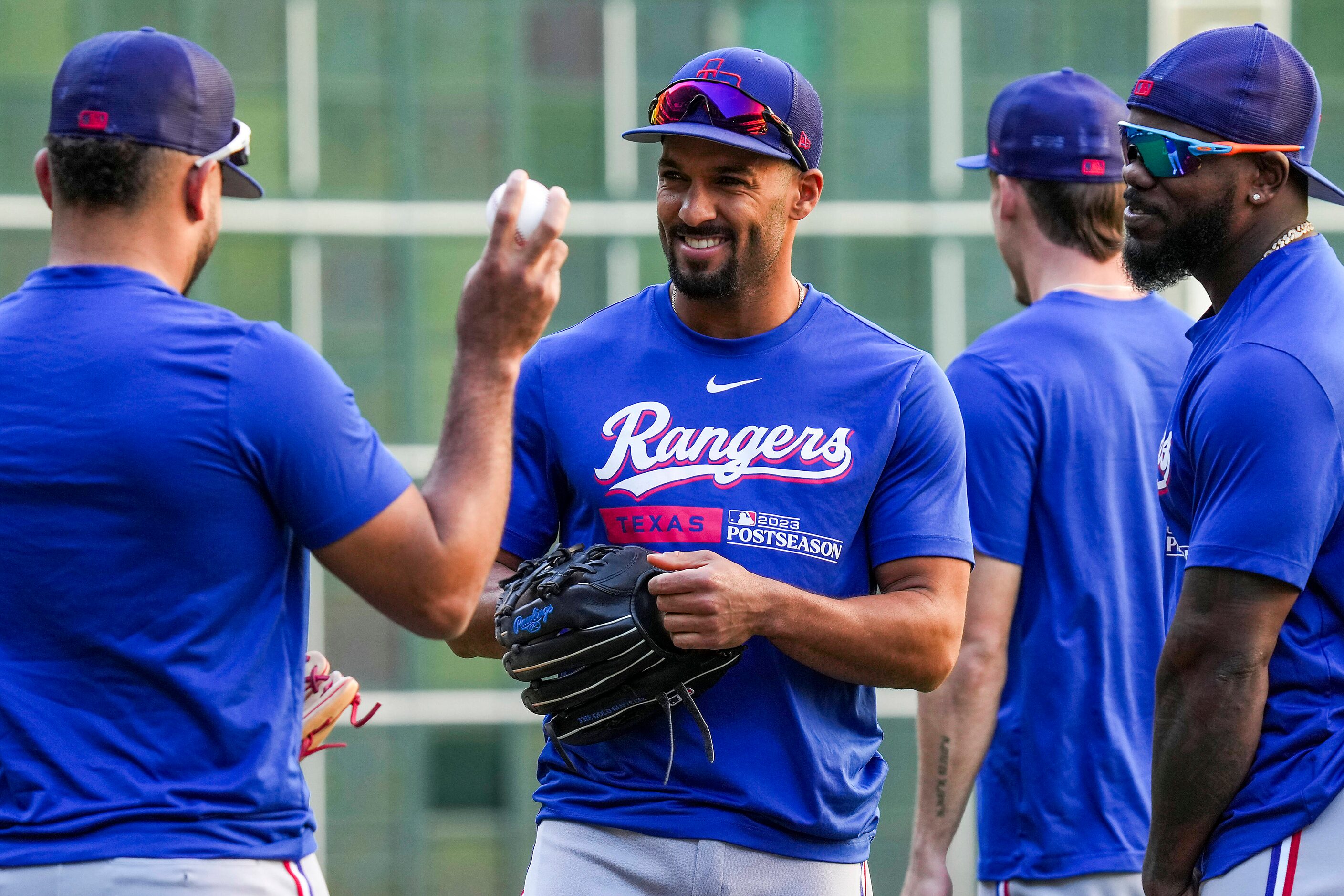 Texas Rangers second baseman Marcus Semien (center) laughs with infielder Ezequiel Duran...