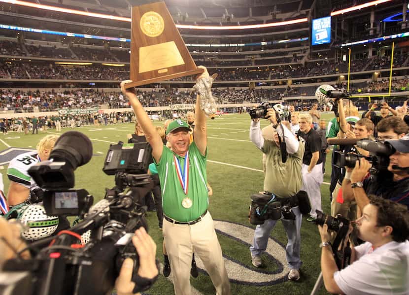 Southlake Carroll Dragons head coach Hal Wasson holds the championship trophy high after the...