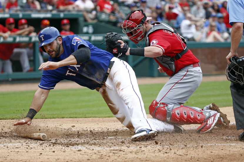 Texas Rangers first baseman Mitch Moreland (18) is called out sliding into home in front of...