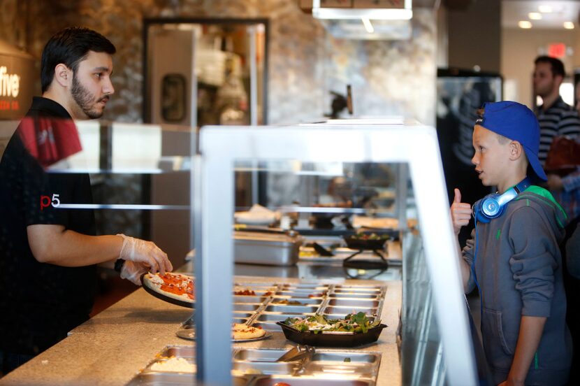 Aidan Veach, 11, gives a thumbs up to Jake Herrera at Pie Five in Lewisville, Texas on...