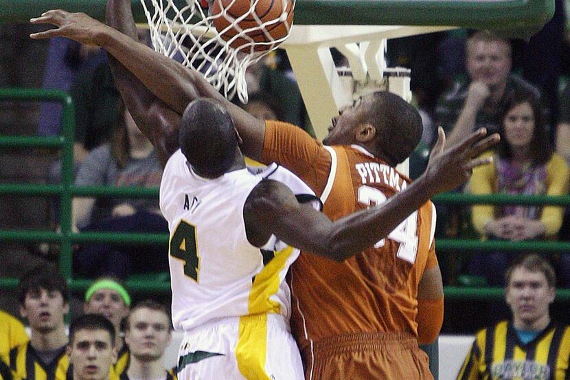 Baylor's Quincy Acy, left, dunks over Texas Dexter Pittman, right, in the first half of an...