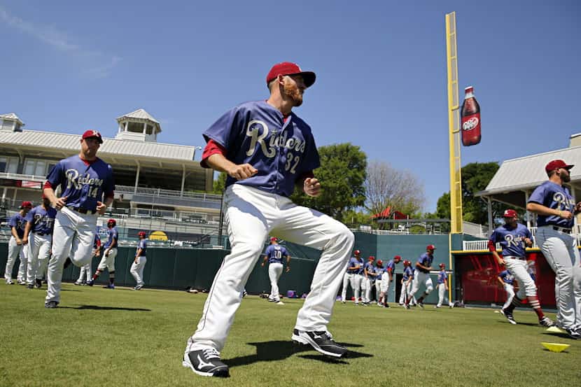 Frisco RoughRiders pitcher Reed Garrett (32) and teammates run drills during media day...