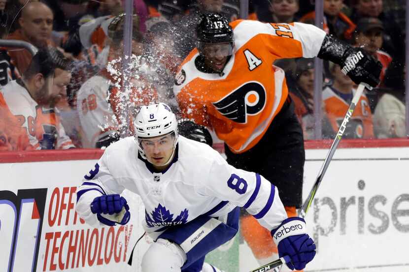 Toronto Maple Leafs' Connor Carrick, left, and Philadelphia Flyers' Wayne Simmonds chase the...