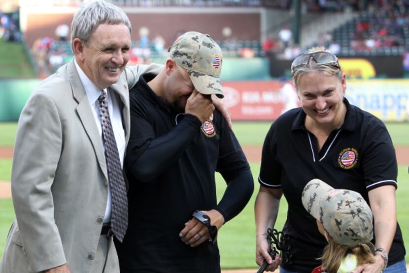 Lt. Gen. Leroy Sisco hugged Sgt. Andrew Brady after Brady, his wife, Amy, and daughter,...