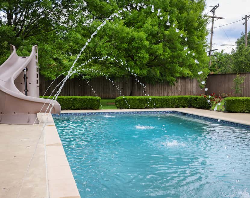 Jets create arcs of water over Ben Kohlmann’s backyard pool in Dallas on April 10. Kohlmann...