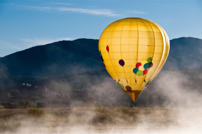 A hot air balloon drifts near the ground in Steamboat Springs.  Because there is no steering...
