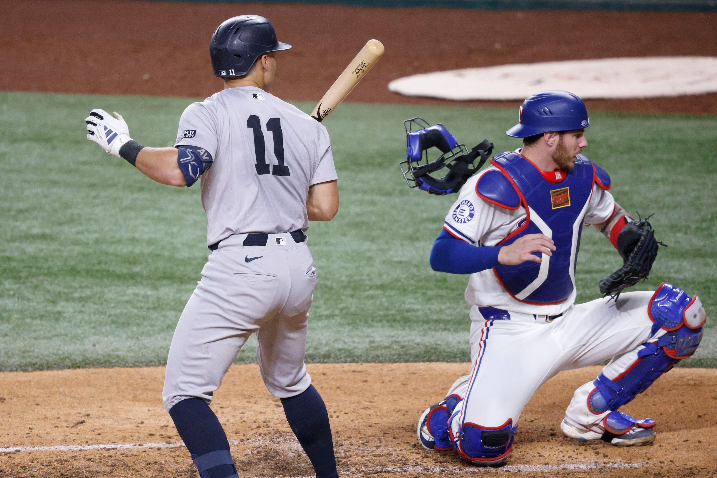 Texas Rangers catcher Jonah Heim (28) loses his mask as he tries to get a wild pitch by...