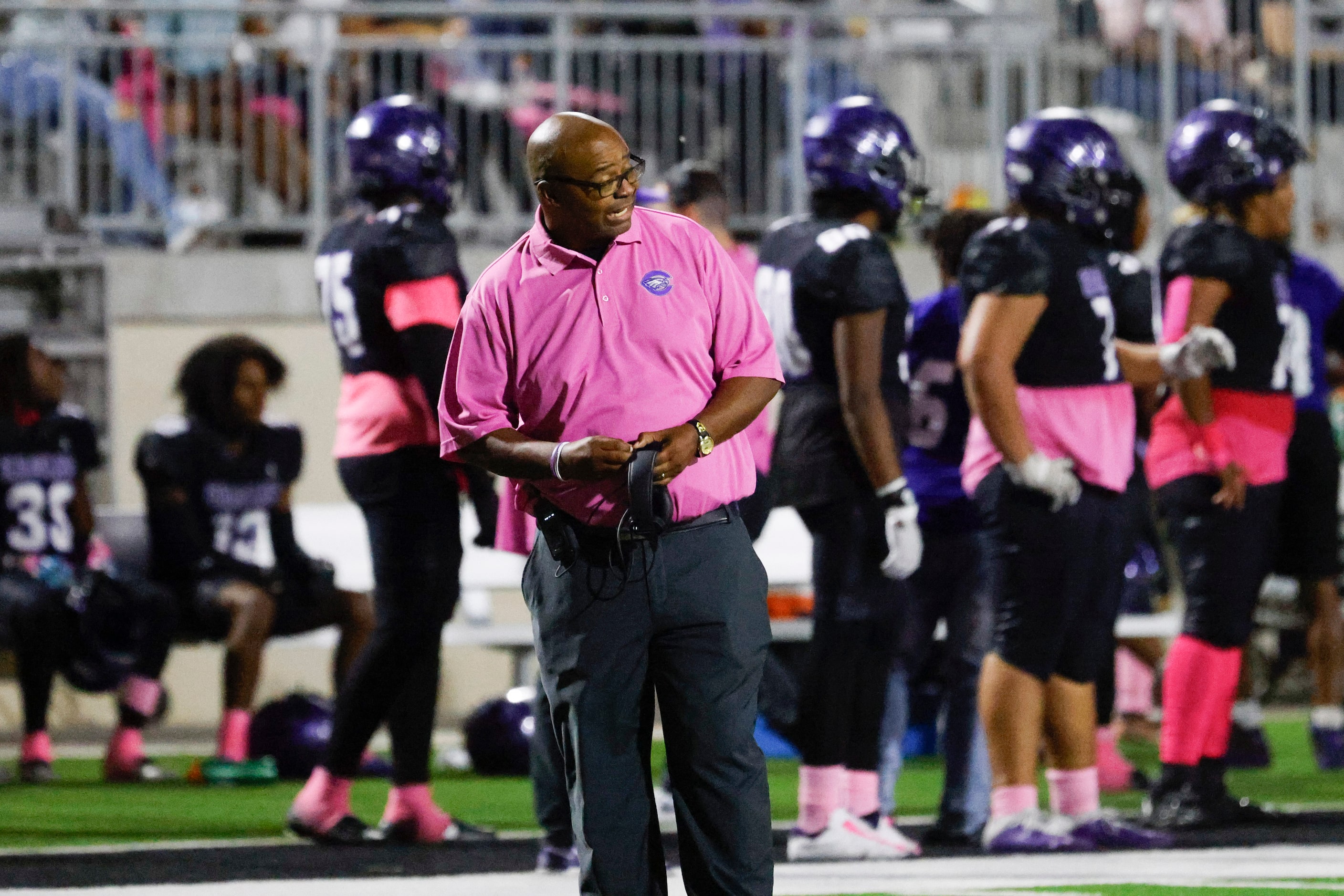 Crowley High head coach Carlos Lynn instructs the team against Trinity High during the first...