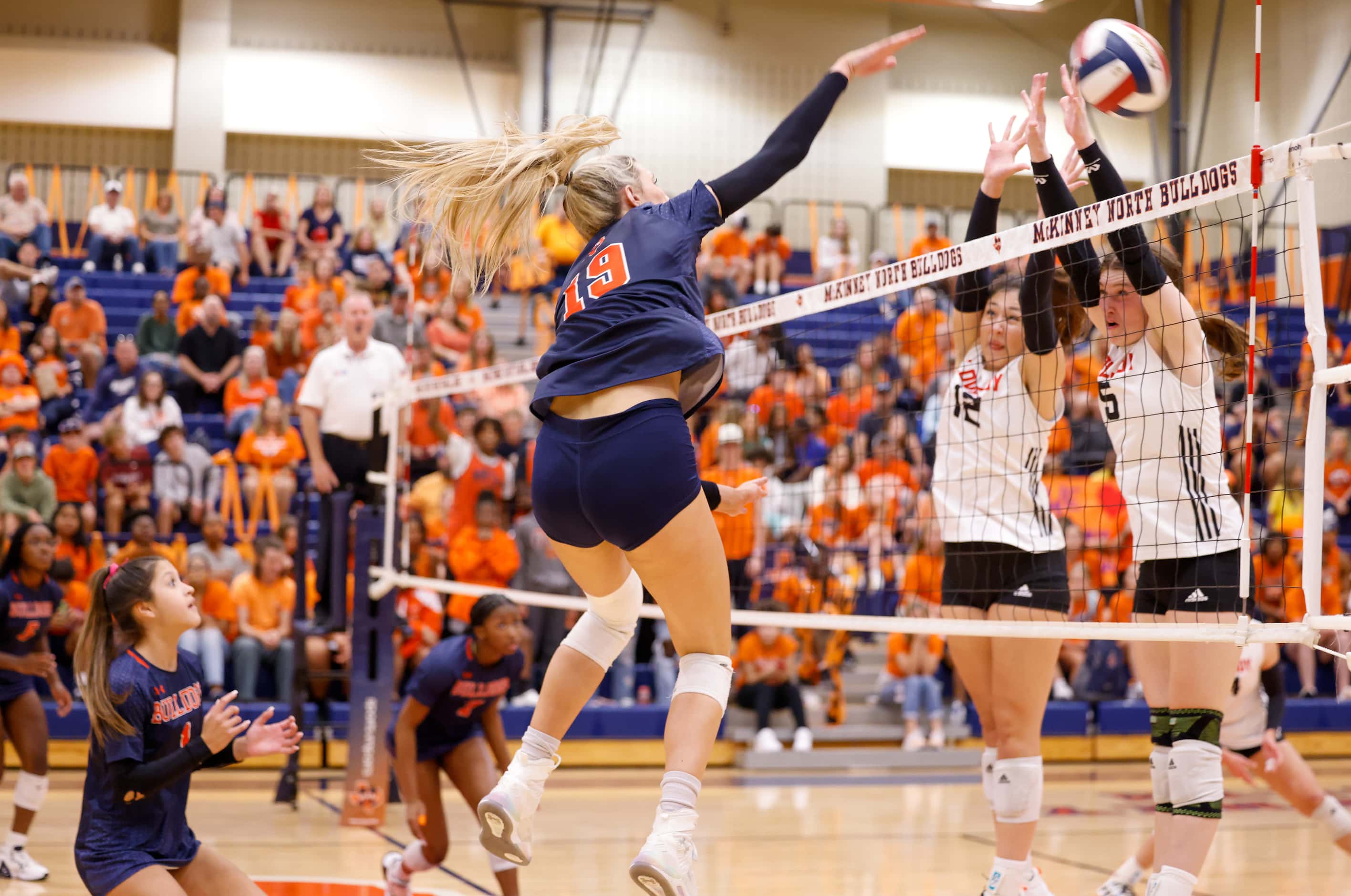 McKinney North Natalie Hughes (19) spikes the winning point into defending Lovejoy players...