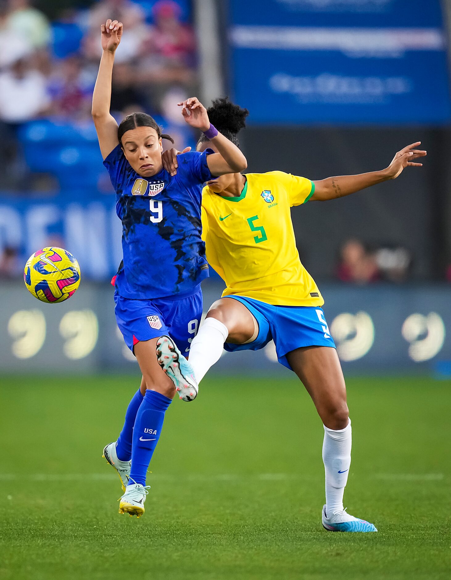 United States forward Mallory Swanson (9) fights for the ball against Brazil defender...