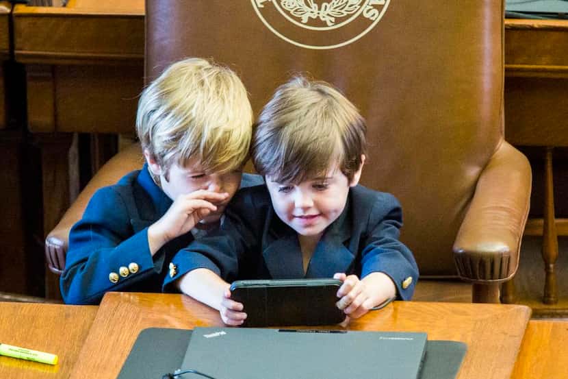 Rep. Dade Phelan’s sons  — Ford, 6, and Mack, 5 — played at their dad’s desk on Monday, the...