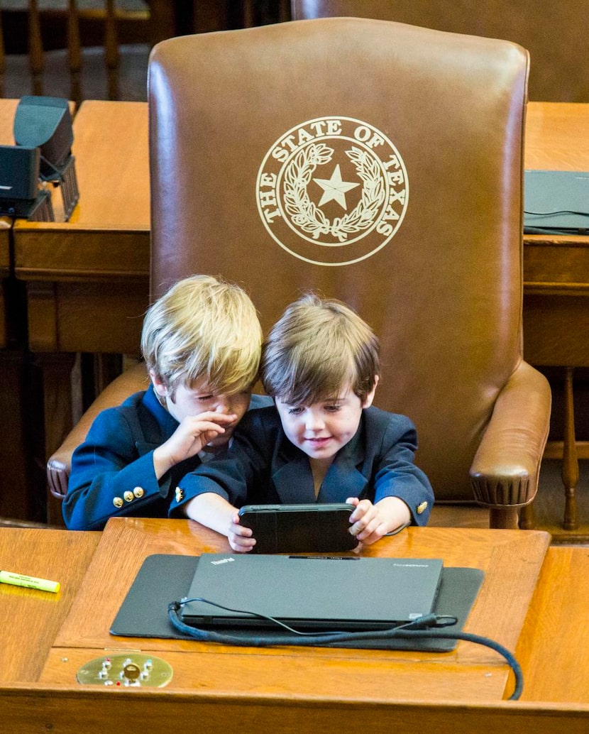 Rep. Dade Phelan’s sons  — Ford, 6, and Mack, 5 — played at their dad’s desk on Monday, the...