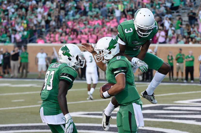 University of North Texas freshman quarterback Mason Fine (6) gets congratulated by Mean...