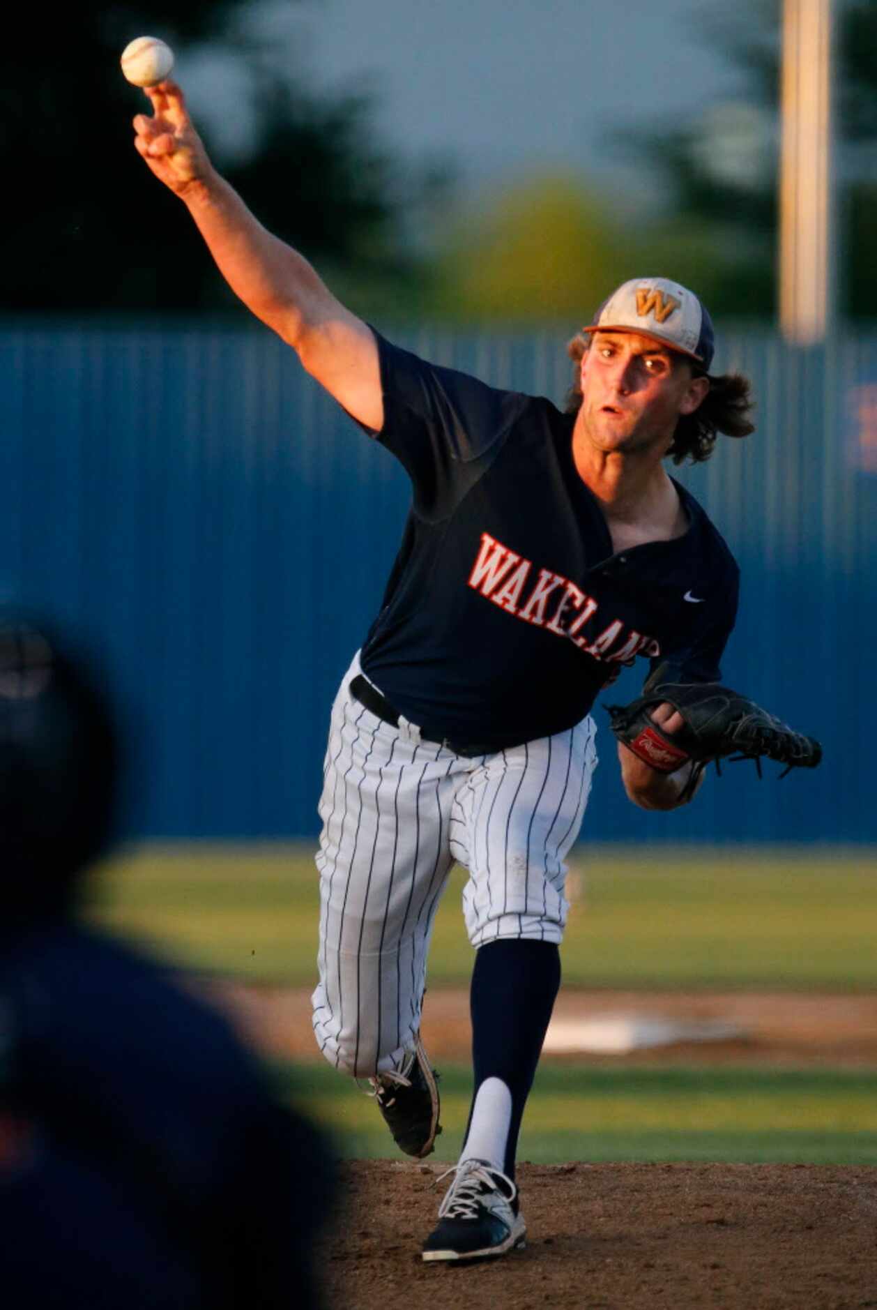 Wakeland High School pitcher Andrew Davis (5) delivers a pitch during the first inning as...