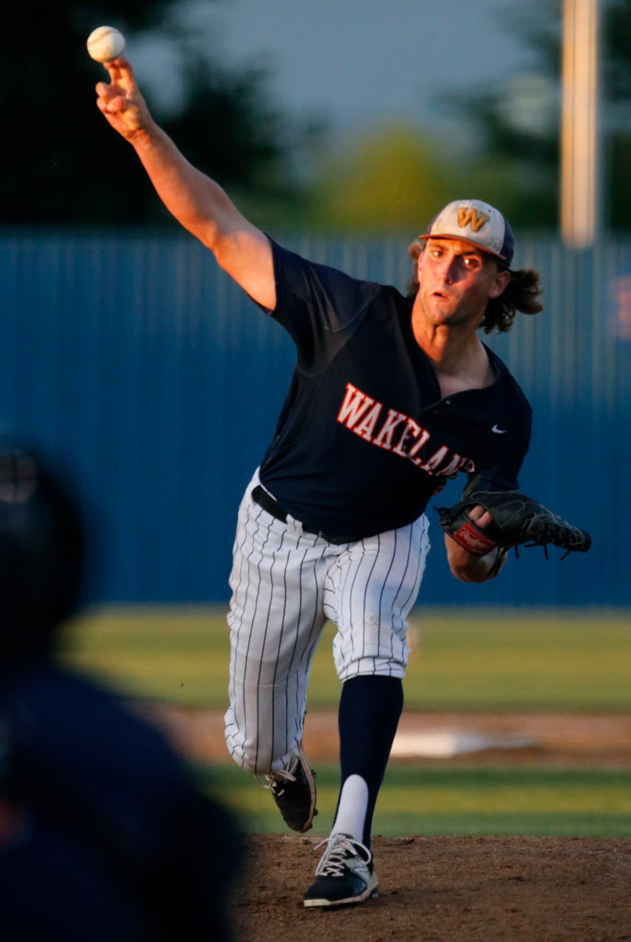 Wakeland High School pitcher Andrew Davis (5) delivers a pitch during the first inning as...