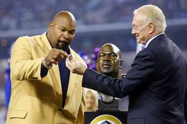 Former Dallas Cowboys guard Larry Allen receives his Hall of Fame ring from owner Jerry...