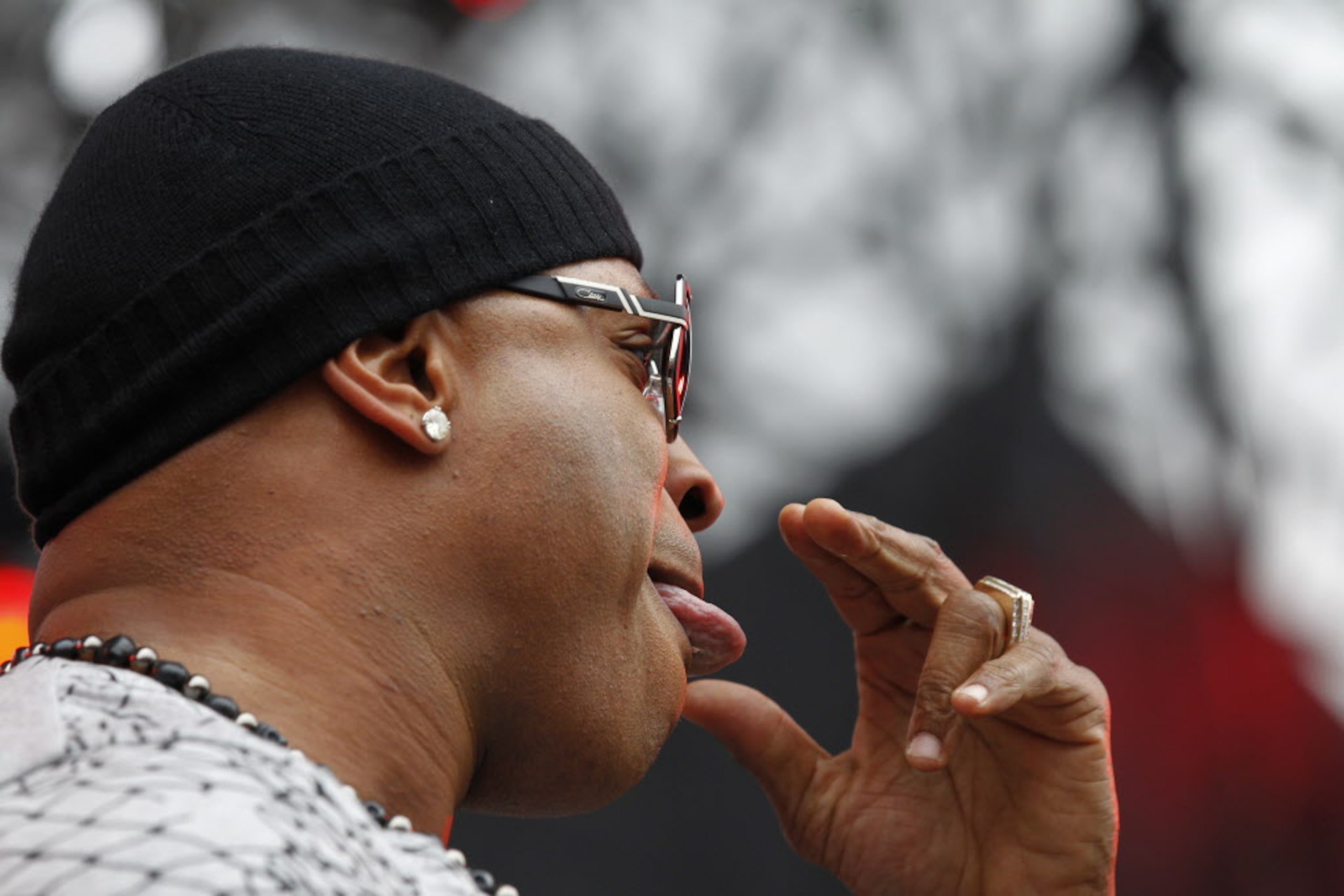 LL Cool J licks his finger tips as he performs during the March Madness Music Festival at...