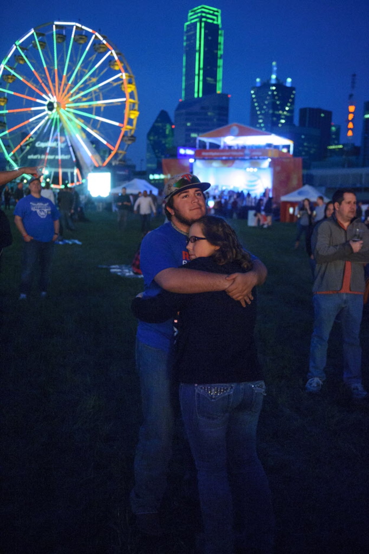 Hunter Benavidez hugs his girlfriend Shelby Richter as they wait for Jason Aldean to take...