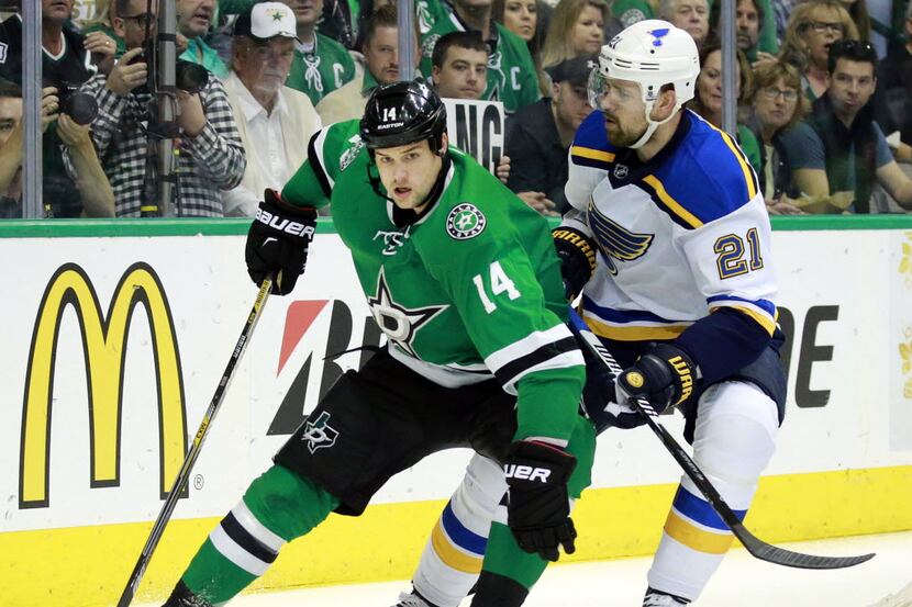 Dallas Stars left wing Jamie Benn (14) circles the back of the net with St. Louis Blues...