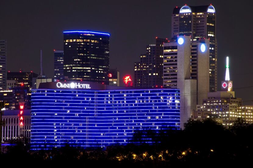 The Omni Dallas Hotel glows blue as downtown Dallas skyline lights up in blue in recognition...