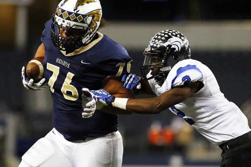 Keller Indians offensive tackle Maea Teuhema (76) goes in for the 7-yard touchdown around...