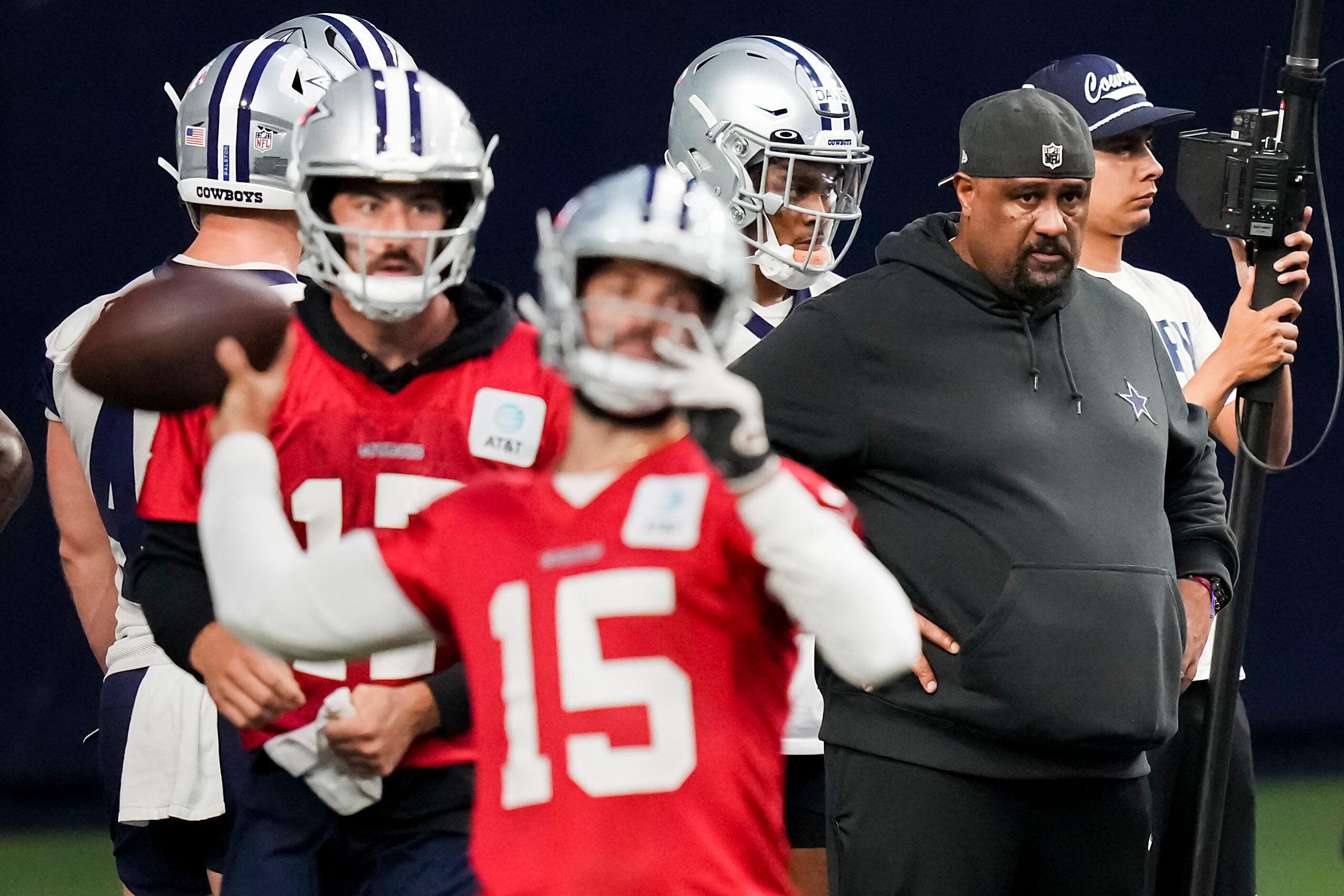 Dallas Cowboys running backs coach Skip Peete (right) watches as quarterback Will Grier (15)...