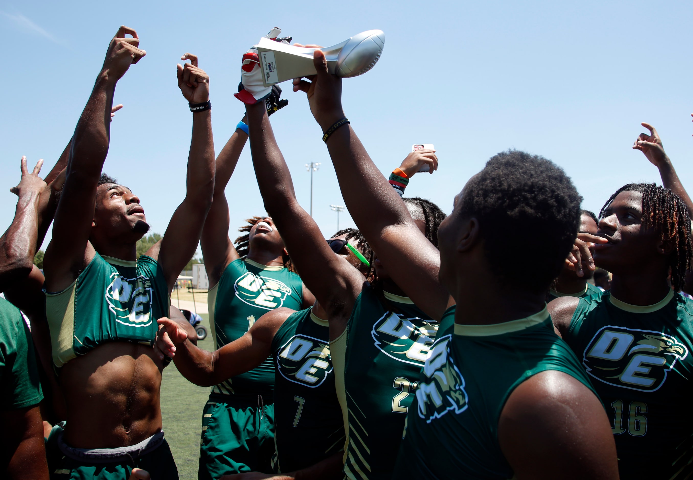 DeSoto Eagles players celebrate as they raise the Division 1 championship trophy after their...