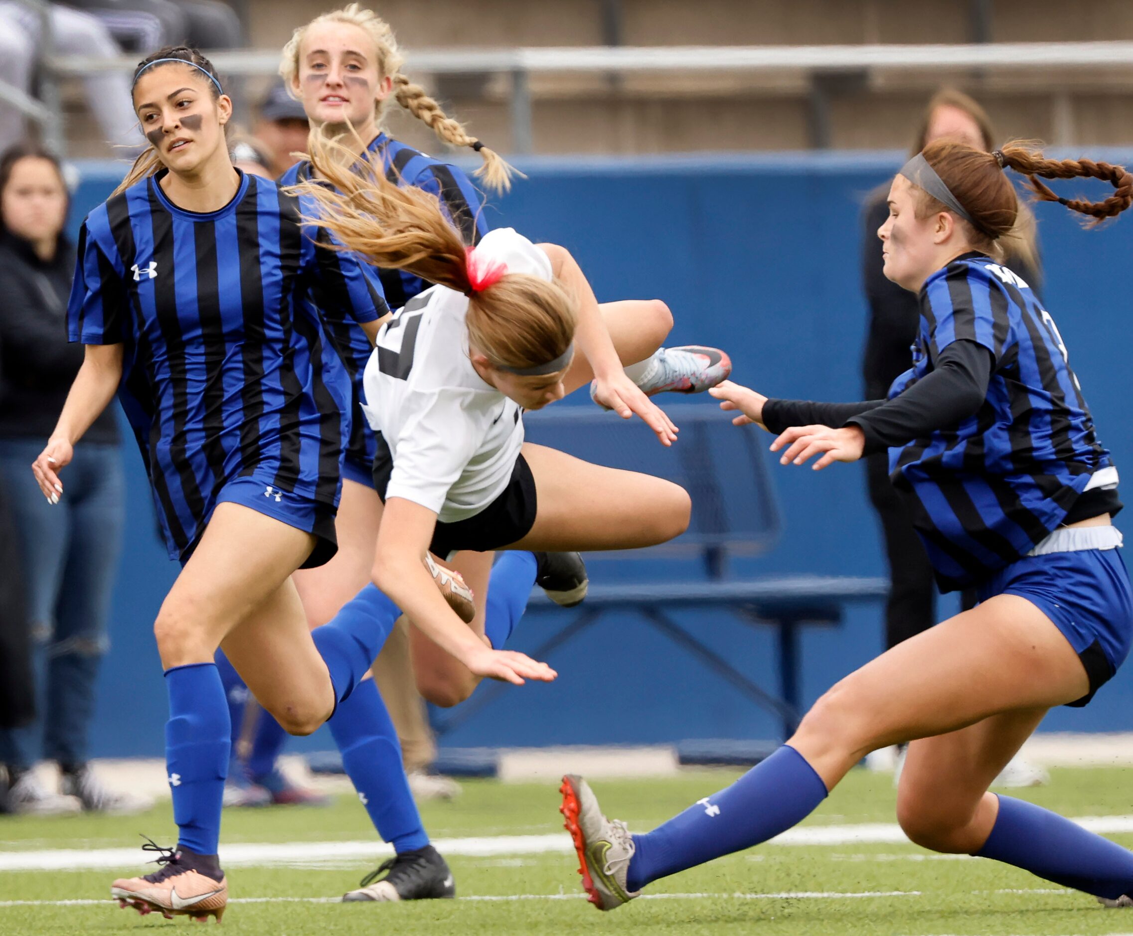 Flower Mound Marcus forward Madi Patterson (17) is sent flying after being tripped by Trophy...