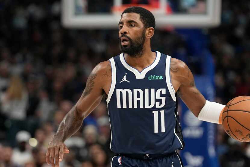 Dallas Mavericks guard Kyrie Irving dribbles during the first half of an NBA basketball game...
