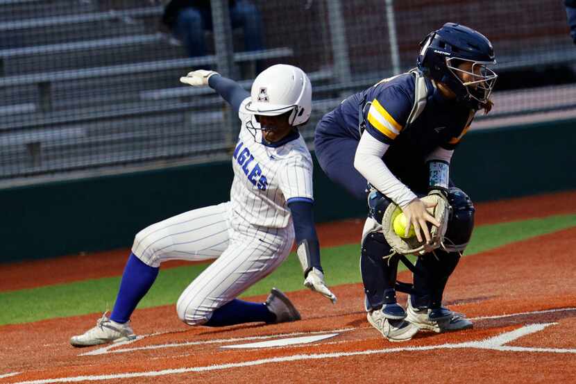 Allen's Jayden Mckinney (9) slides safely into home plate before a tag by McKinney's...