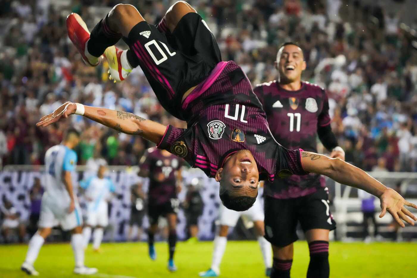 Mexico midfielder Orbelin Pineda celebrates with a flip after scoring past Guatemala...