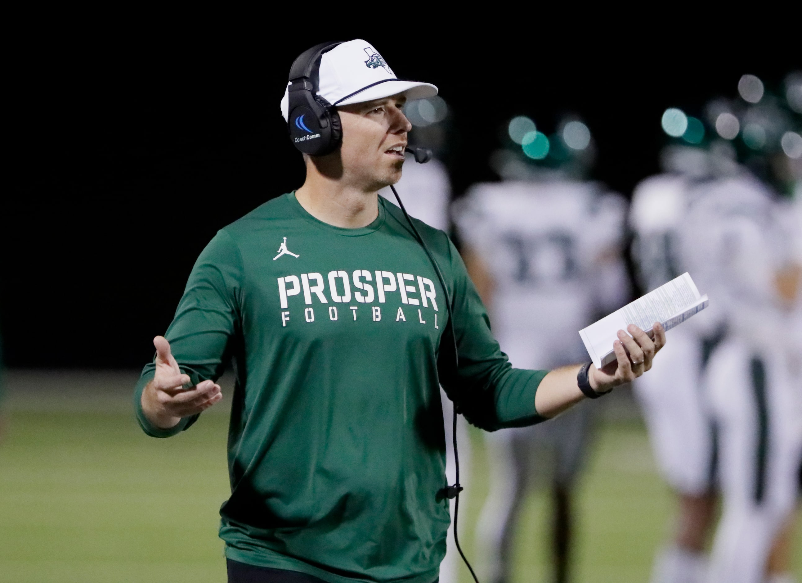 Prosper High School head coach Tyler Moore asks for clarification during the first half as...