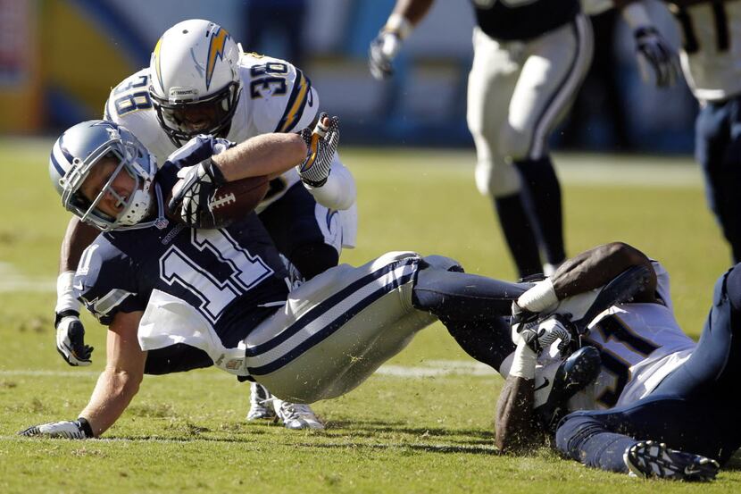 Dallas Cowboys wide receiver Cole Beasley (11) is tackled by San Diego Chargers strong...