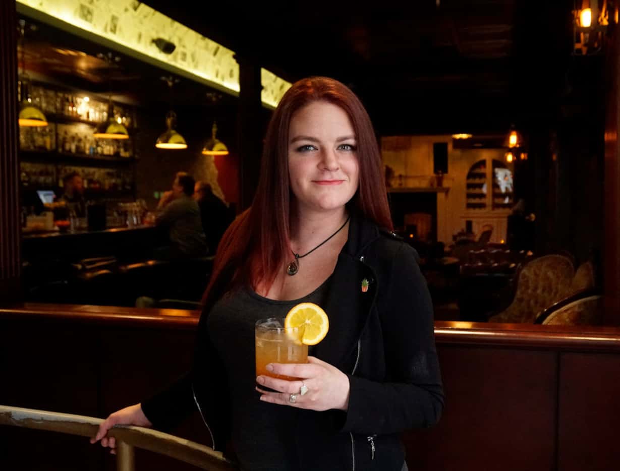 Thompson's Bookstore beverage director Brittany Day holds a mocktail at the bar in Fort...